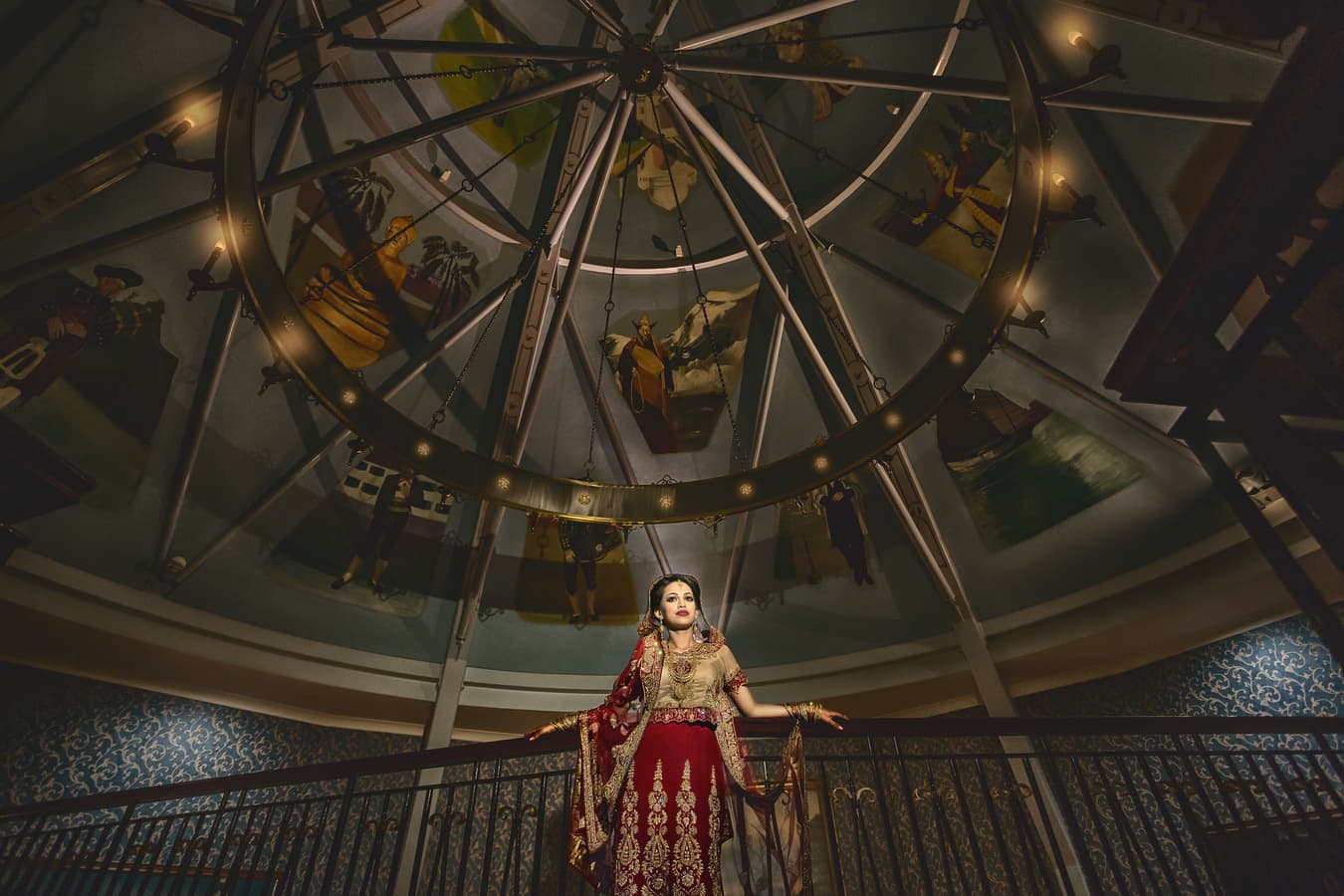 Bride in red dress under a domed ceiling, challenging lighting corrected, color correction for dramatic tones, and background cleanup for symmetry