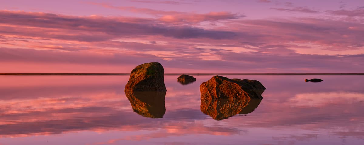 Coastal stones at twilight, color and light refinement with artistic grading for cinematic, moody atmosphere