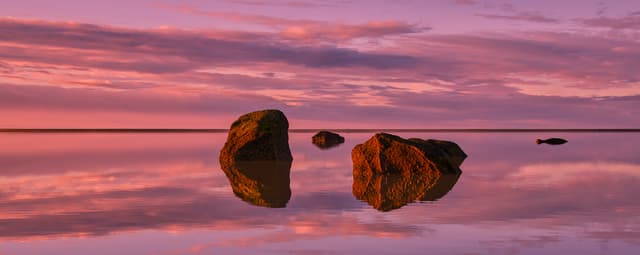 Coastal stones at twilight, color and light refinement with artistic grading for cinematic, moody atmosphere