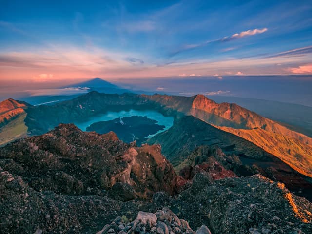 Mountain crater lake at sunrise with dramatic sky; color correction, sky enhancement, and natural and accurate color balancing