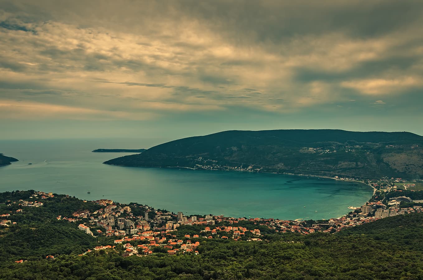 Dramatic coastal landscape at dusk; sky enhancement, weathered buildings cleaned up, and natural color grading for cinematic travel mood