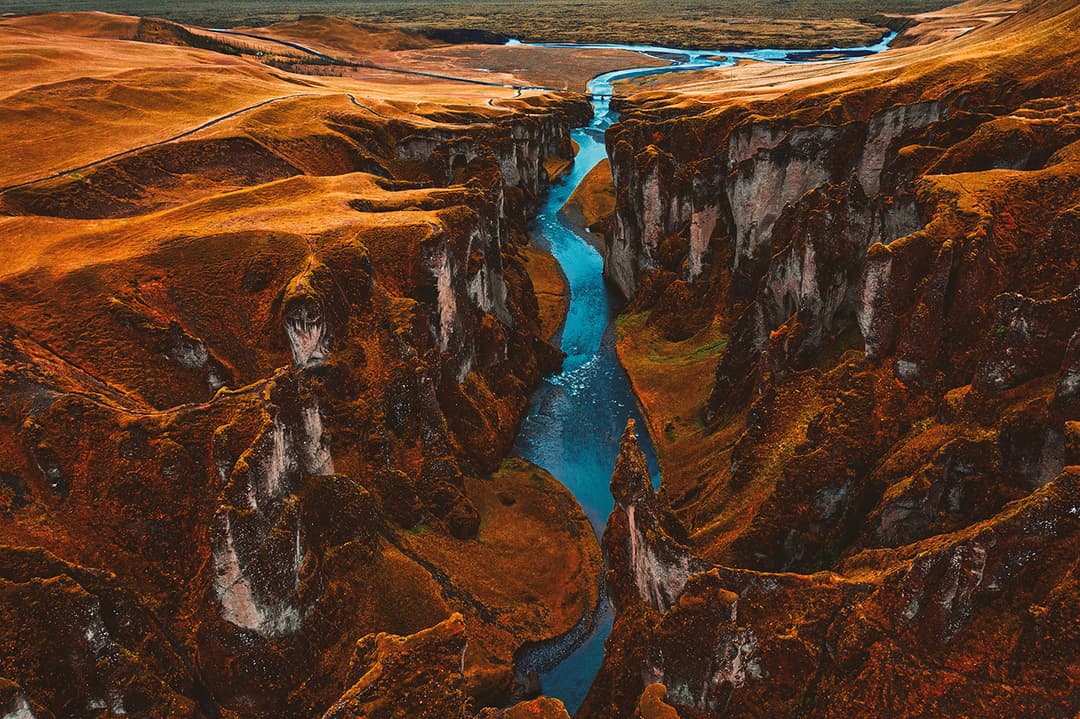 Aerial canyon view with turquoise river; color correction, natural and accurate color balancing, matching tones across the set